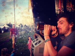 Blowing a horn at Cornbury Music Festival